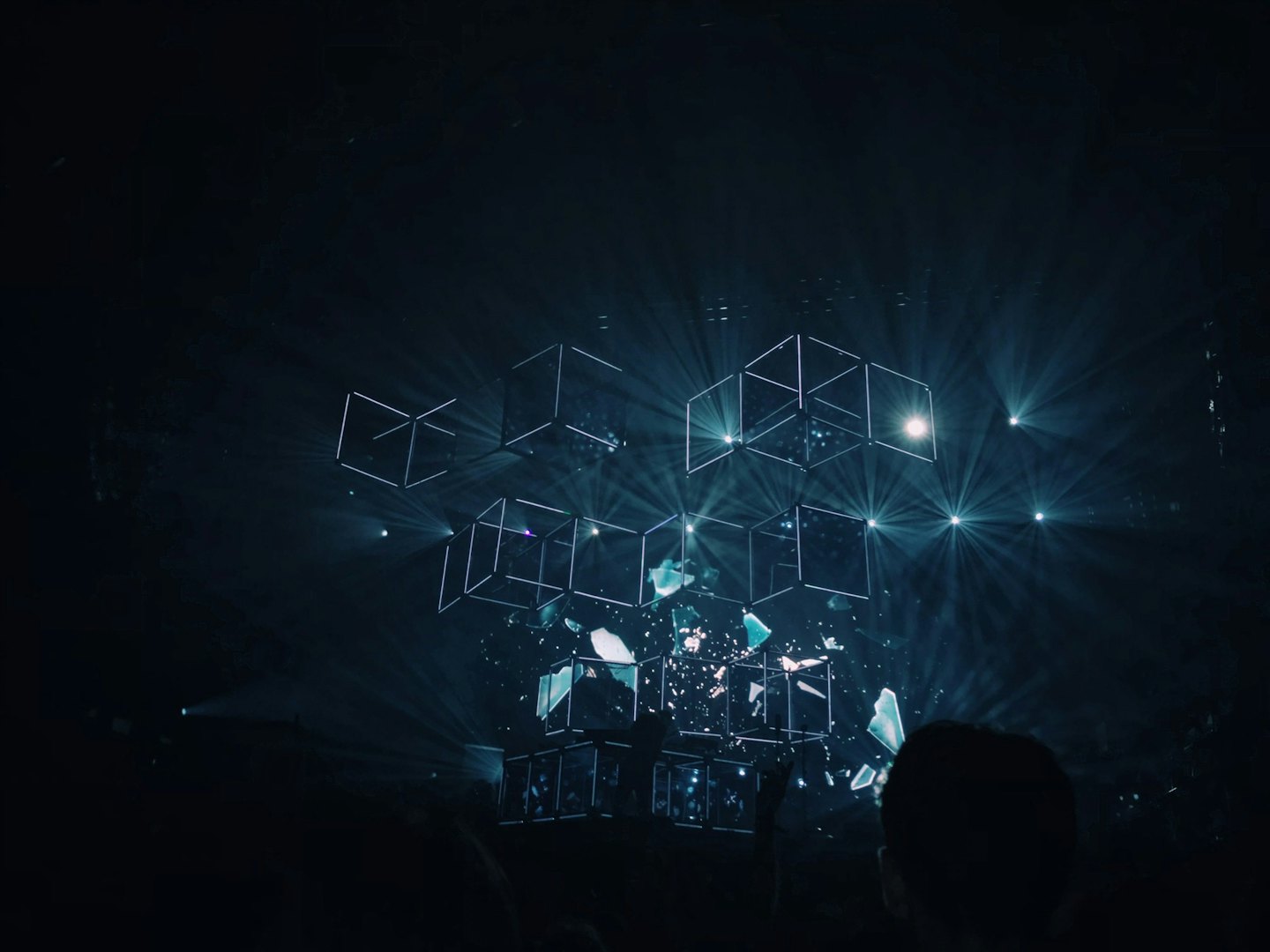 Glowing wireframe cubes and shattered geometric shapes.